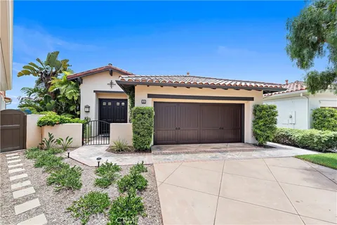 a front view of a house with a garage and a yard