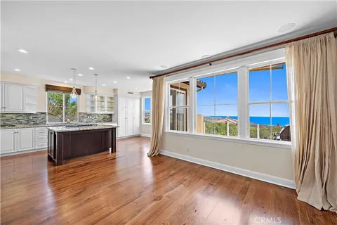 a open kitchen with a refrigerator and a stove top oven