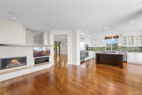 a large open kitchen with a refrigerator a stove top oven a sink and dishwasher