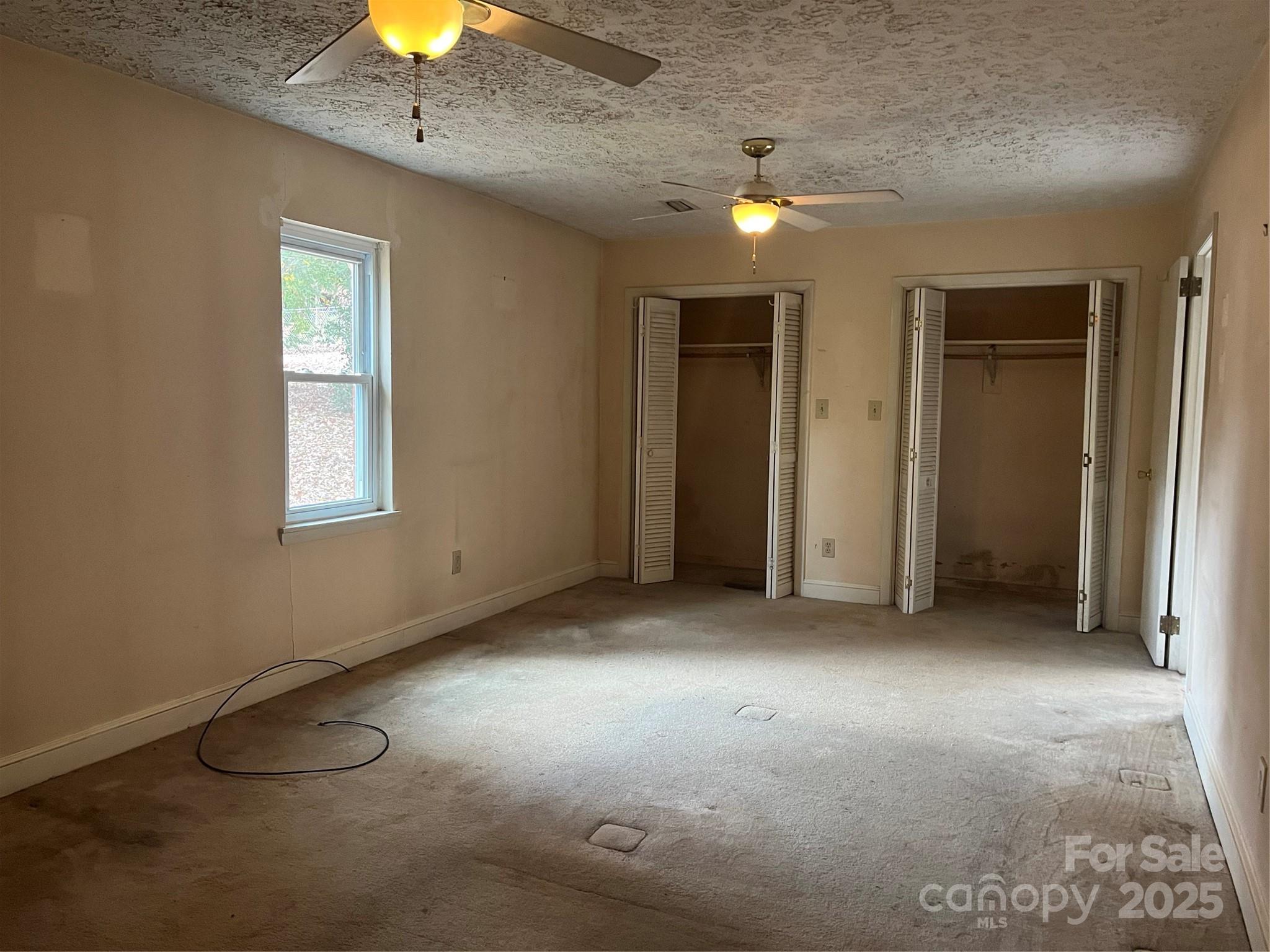 302 Walton Road Morganton, NC 28655 - Photo 12 of 21 an empty room with a window and chandelier fan