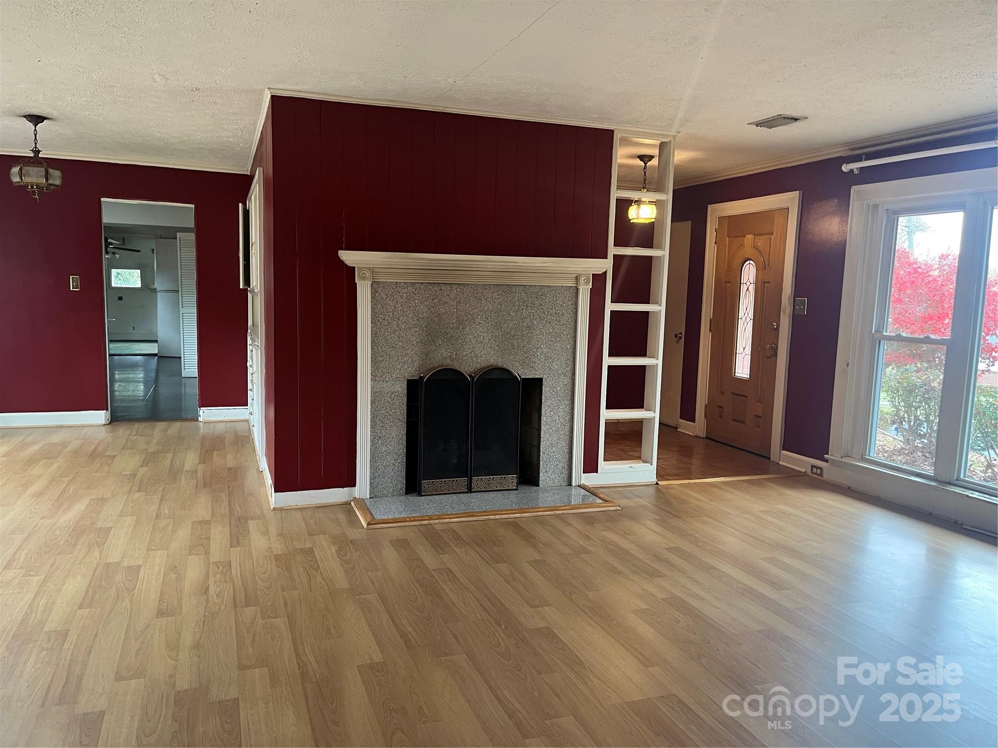 302 Walton Road Morganton, NC 28655 - Photo 2 of 21 a view of an empty room with wooden floor and a fireplace