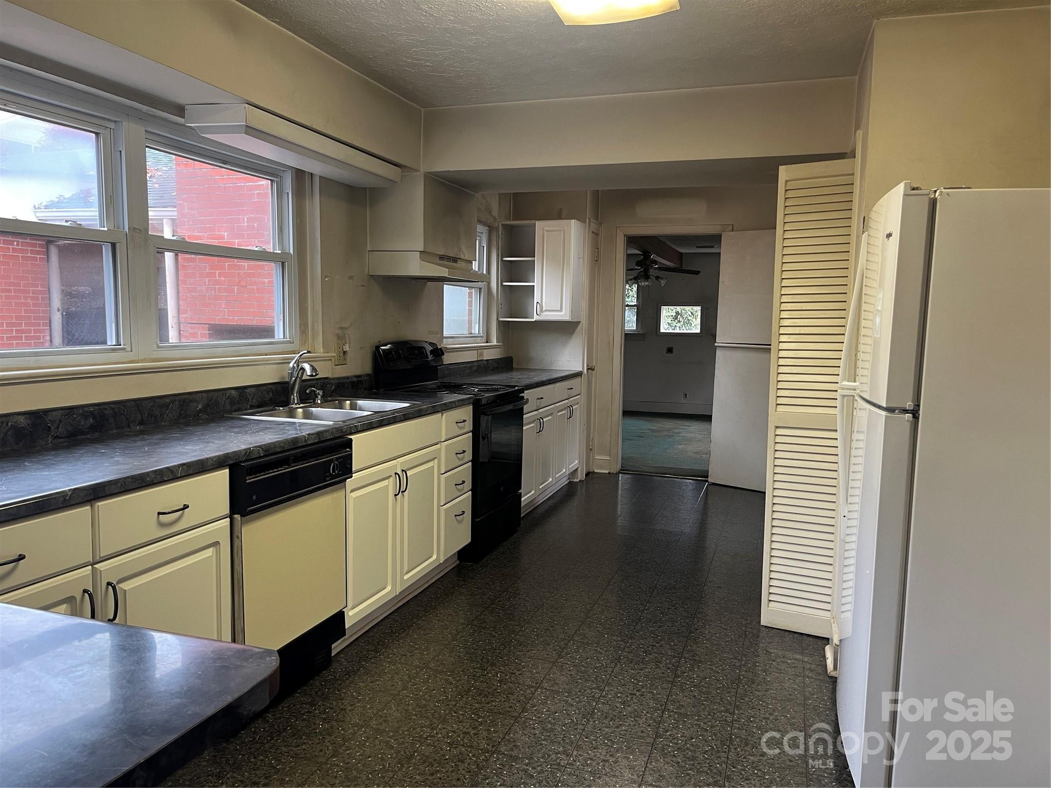 302 Walton Road Morganton, NC 28655 - Photo 3 of 21 a kitchen with stainless steel appliances granite countertop a sink stove and refrigerator