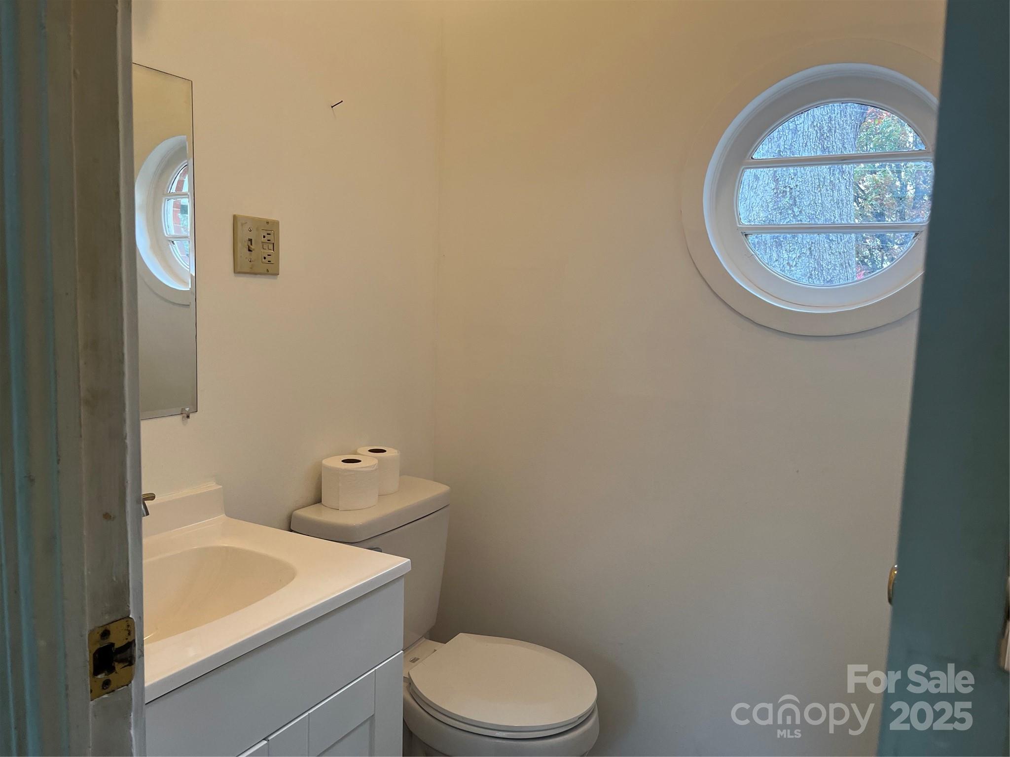 302 Walton Road Morganton, NC 28655 - Photo 6 of 21 a bathroom with a toilet a sink and a mirror