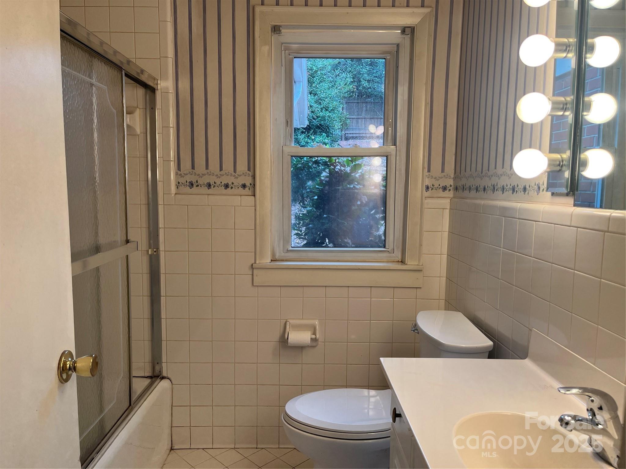 302 Walton Road Morganton, NC 28655 - Photo 10 of 21 a white toilet sitting next to a bathroom sink