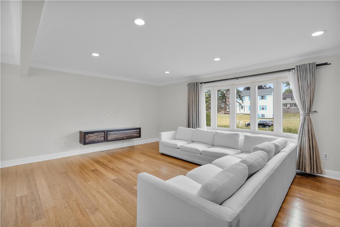 3396 Darien Road Bethlehem, PA 18020 - Photo 19 of 44 Recessed lighting illuminates this bright living area with warm wood flooring and a large picture window.