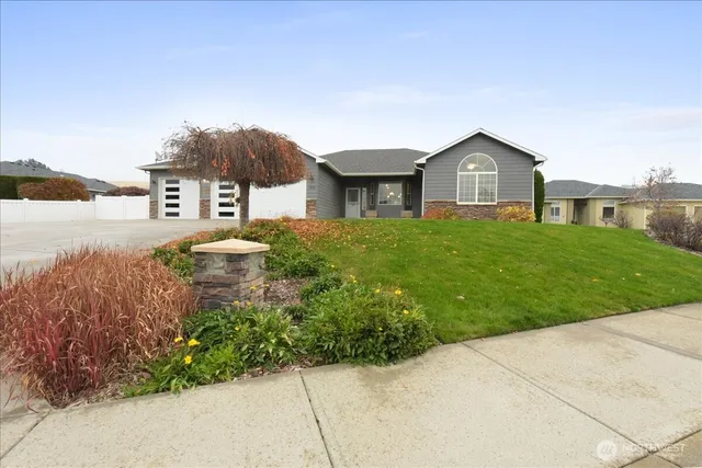 a front view of a house with a yard and garage