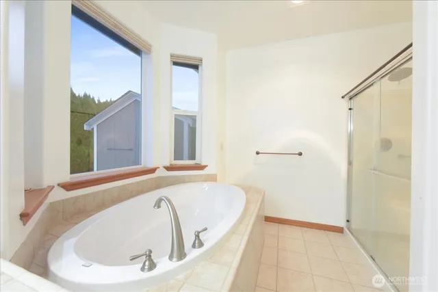 a bathroom with a tub and shower