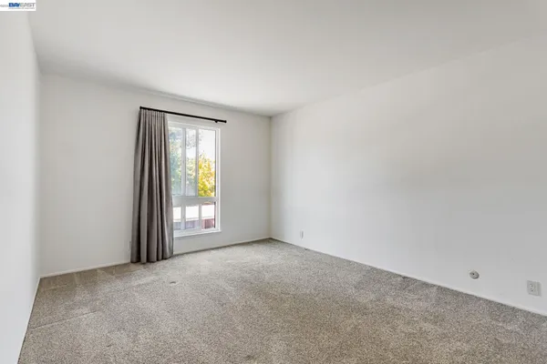 a bedroom with a large bed and a potted plant