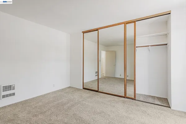 a view of an empty room with a closet