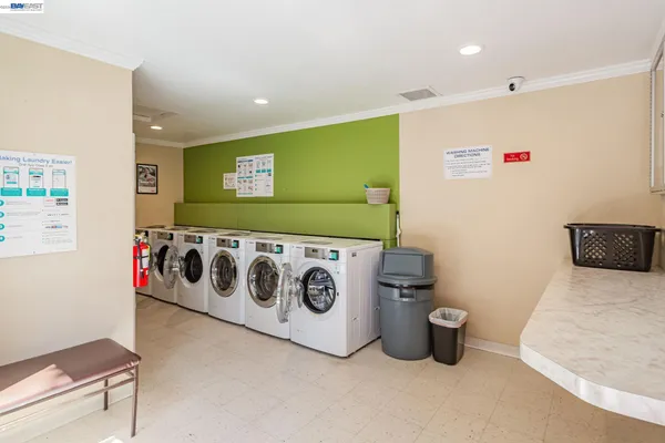 a view of kitchen with kitchen island stainless steel appliances refrigerator stove microwave and chair