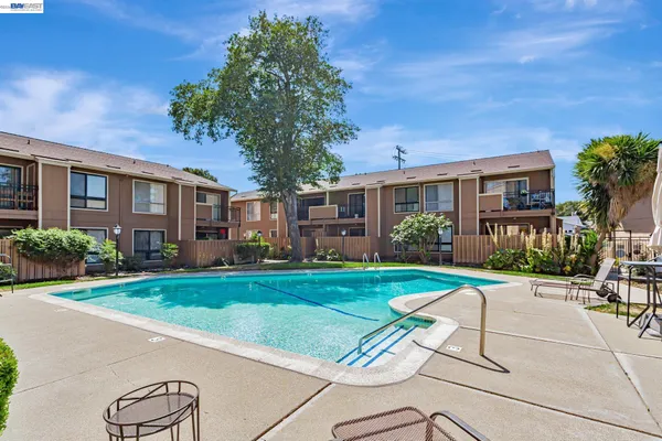 a view of a house with backyard sitting area and garden