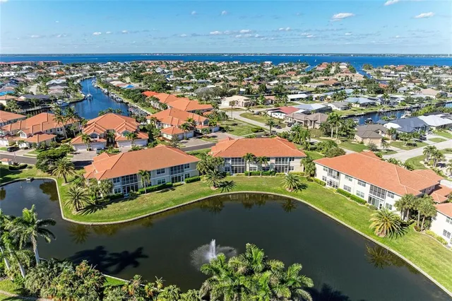 an aerial view of residential houses with outdoor space and river