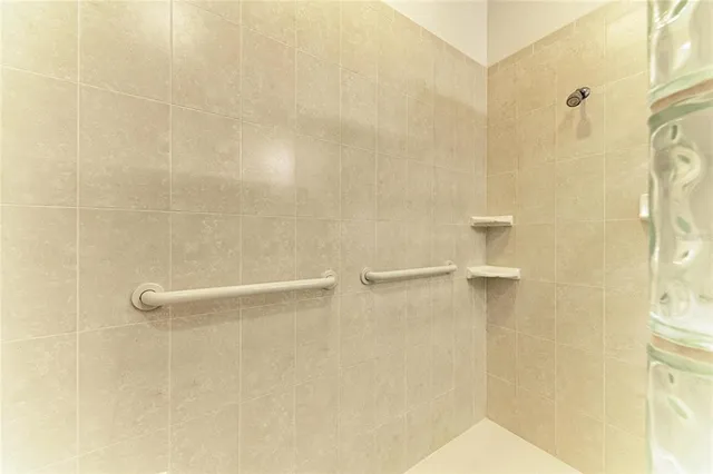 a bathroom with a granite countertop sink and a toilet