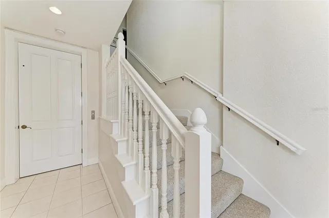 a hallway with painting and a large window