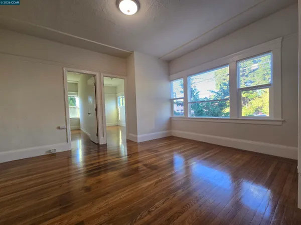 a living room with lots of furniture and a floor to ceiling window