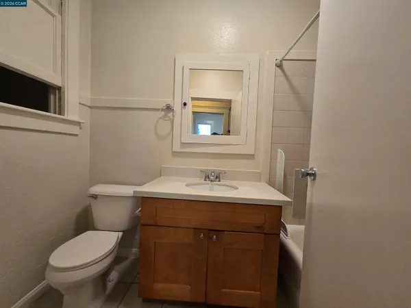 a living room with furniture a wooden floor and next to a window