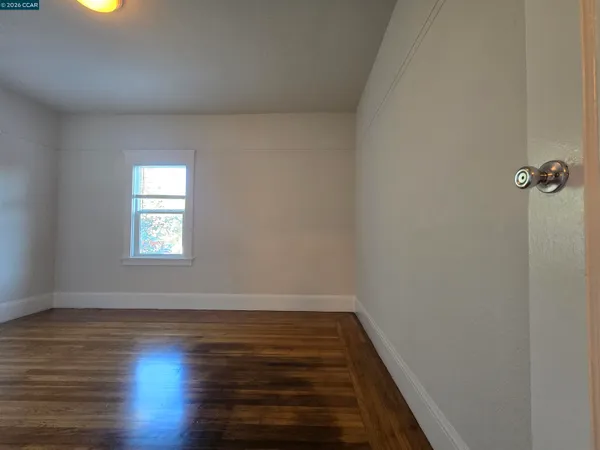 a kitchen with a table chairs and a refrigerator