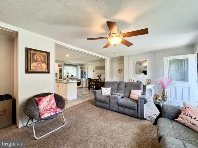 a living room with furniture and kitchen view