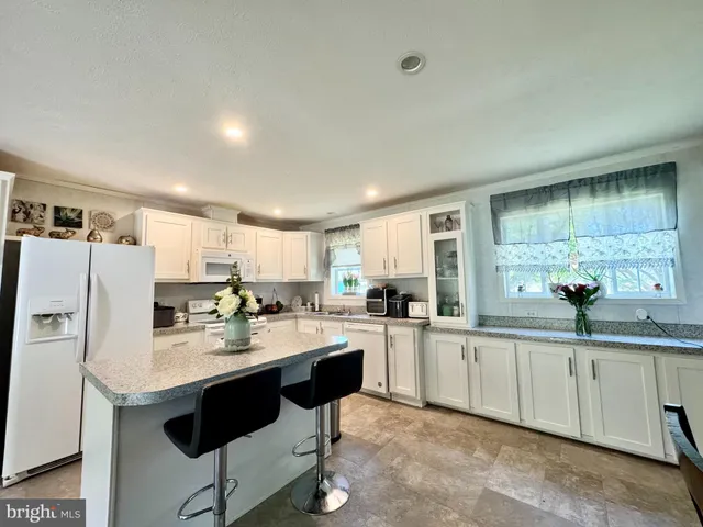 a kitchen with refrigerator and cabinets