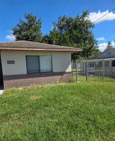 a backyard of a house with table and chairs