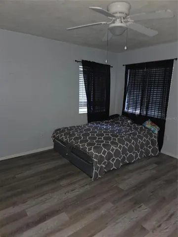 a bedroom with wooden floor