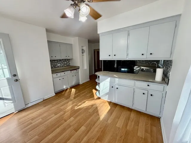 a kitchen with granite countertop white cabinets and white appliances
