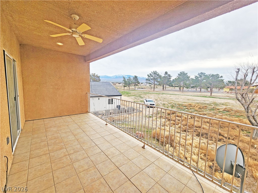 1421 Star Road, Unit 2 Pahrump, NV 89048 - Photo 28 of 33 Balcony with ceiling fan and a mountain view