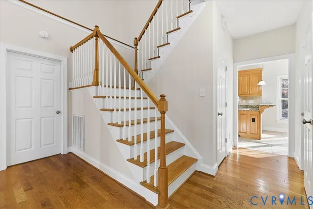 a view of entryway with wooden floor and stairs
