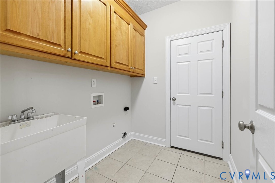 11891 Old Stage Road Prince George, VA 23875 - Photo 13 of 38 Laundry room featuring washer hookup, cabinet spac