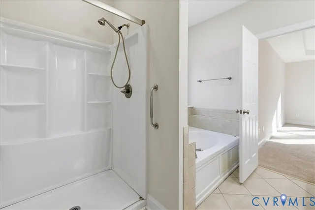 a bathroom with a bath tub with a shower