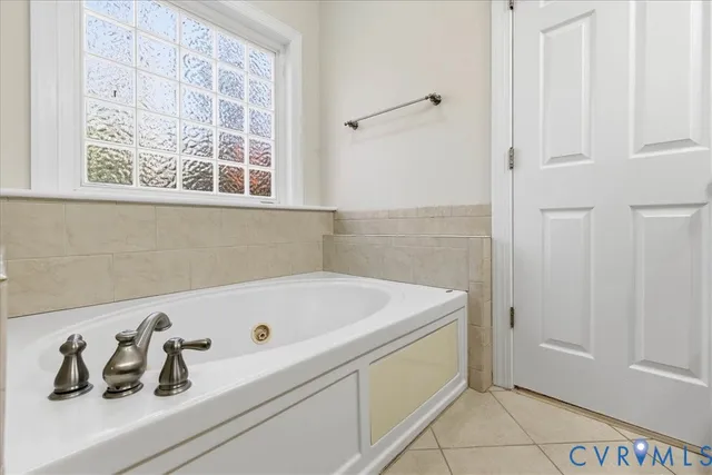 a bathroom with a tub and sink