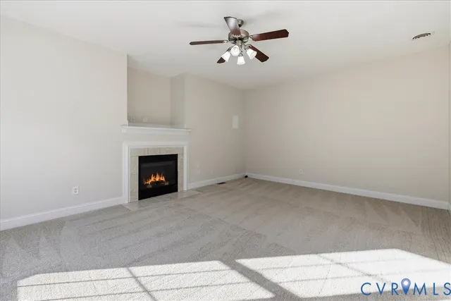 a view of an empty room with a fireplace