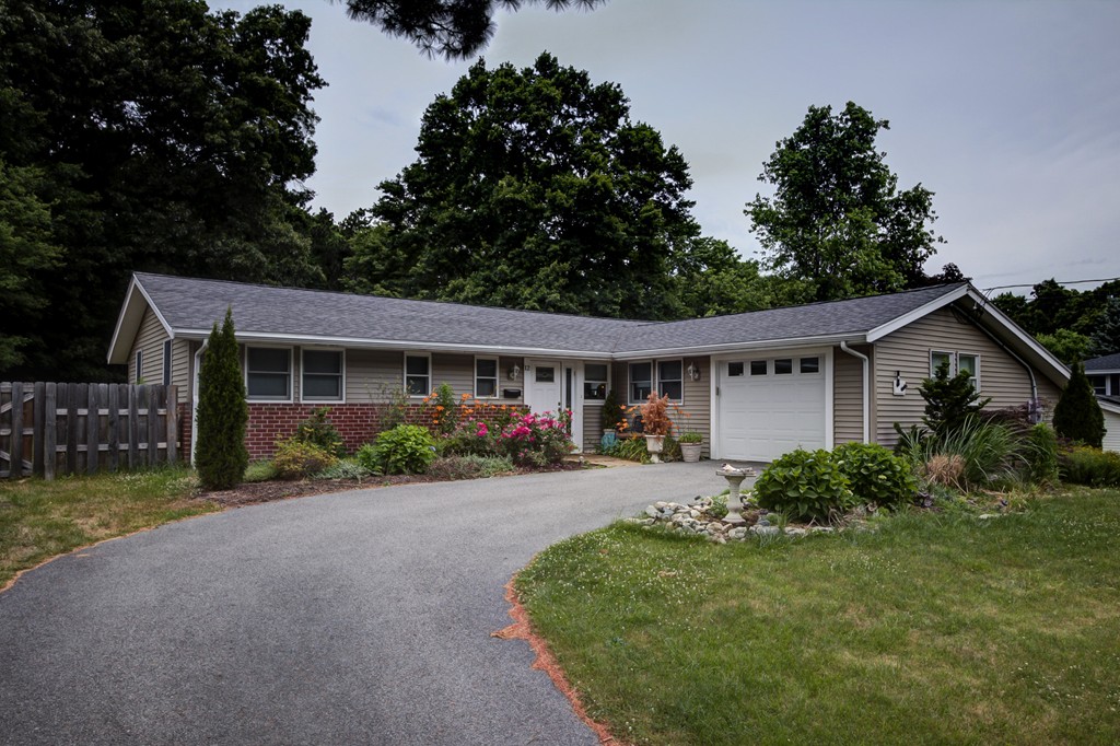a front view of house with yard and green space