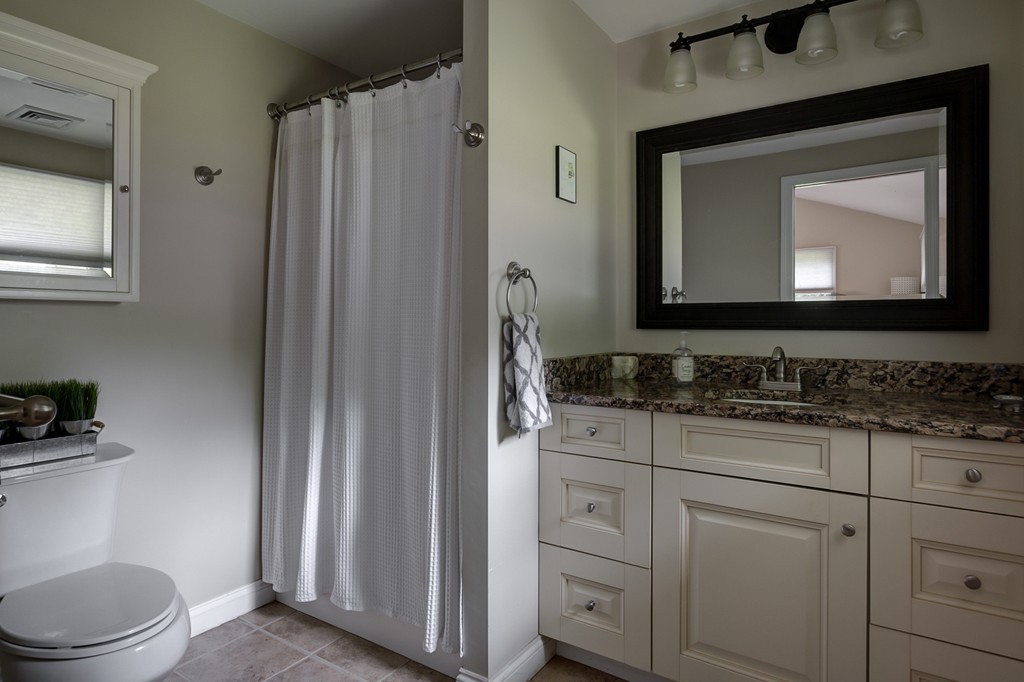 12 Amy Road Framingham, MA 01701 - Photo 20 of 30 a bathroom with a toilet a sink a vanity and mirror