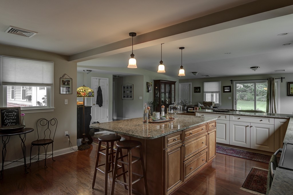 12 Amy Road Framingham, MA 01701 - Photo 5 of 30 a kitchen with center island table and chairs in it