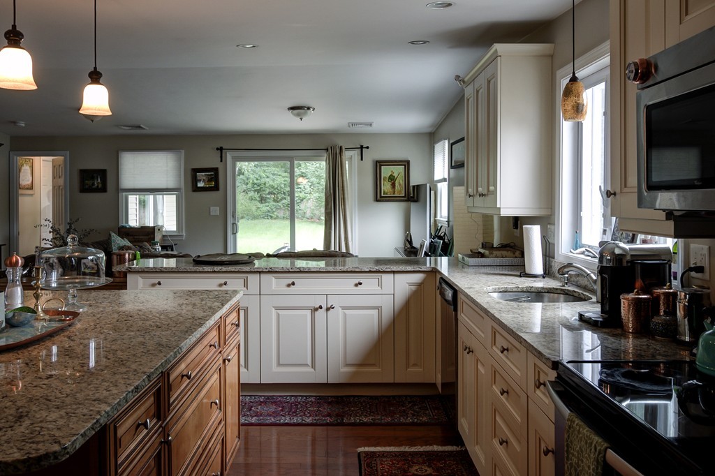 12 Amy Road Framingham, MA 01701 - Photo 6 of 30 a kitchen with granite countertop a sink a counter space appliances and cabinets