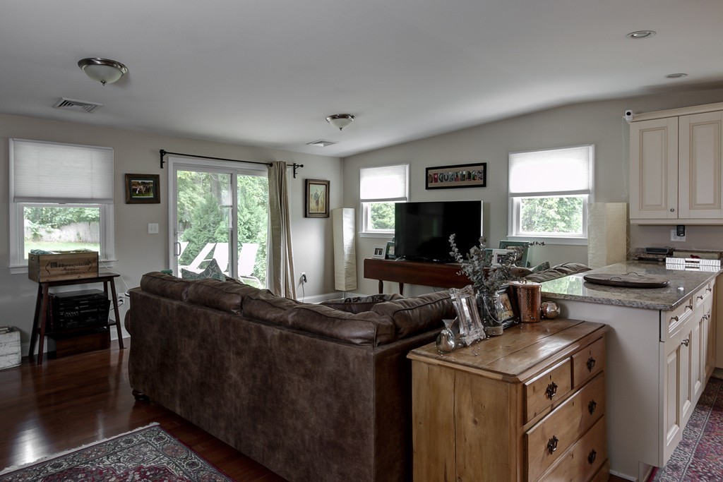 12 Amy Road Framingham, MA 01701 - Photo 7 of 30 a kitchen with a stove top oven a sink a dining table and chairs