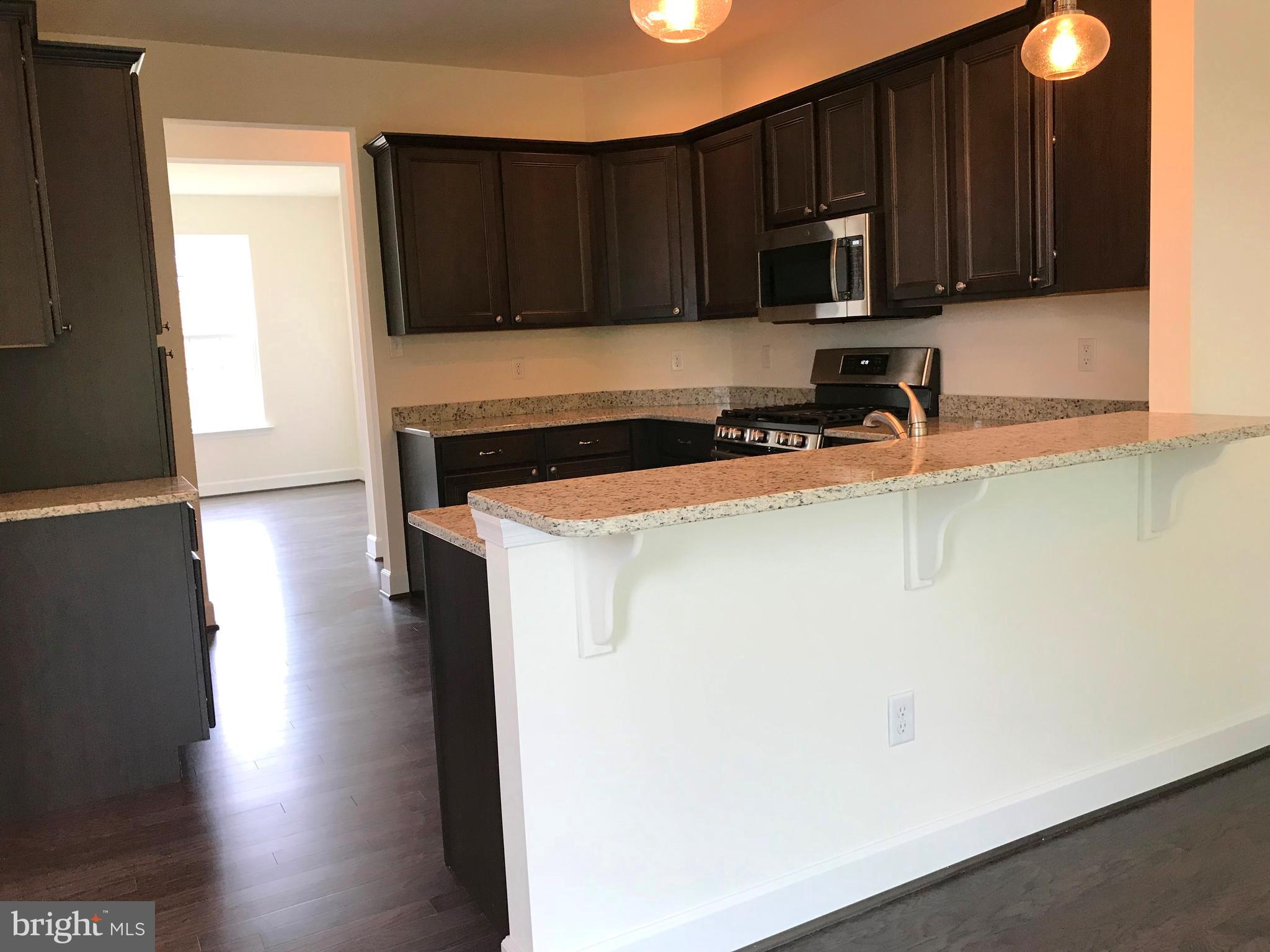 860 Ripple Drive, Unit 76 Hanover, PA 17331 - Photo 11 of 16 Kitchen- granite, stainless, gas, hardwoods