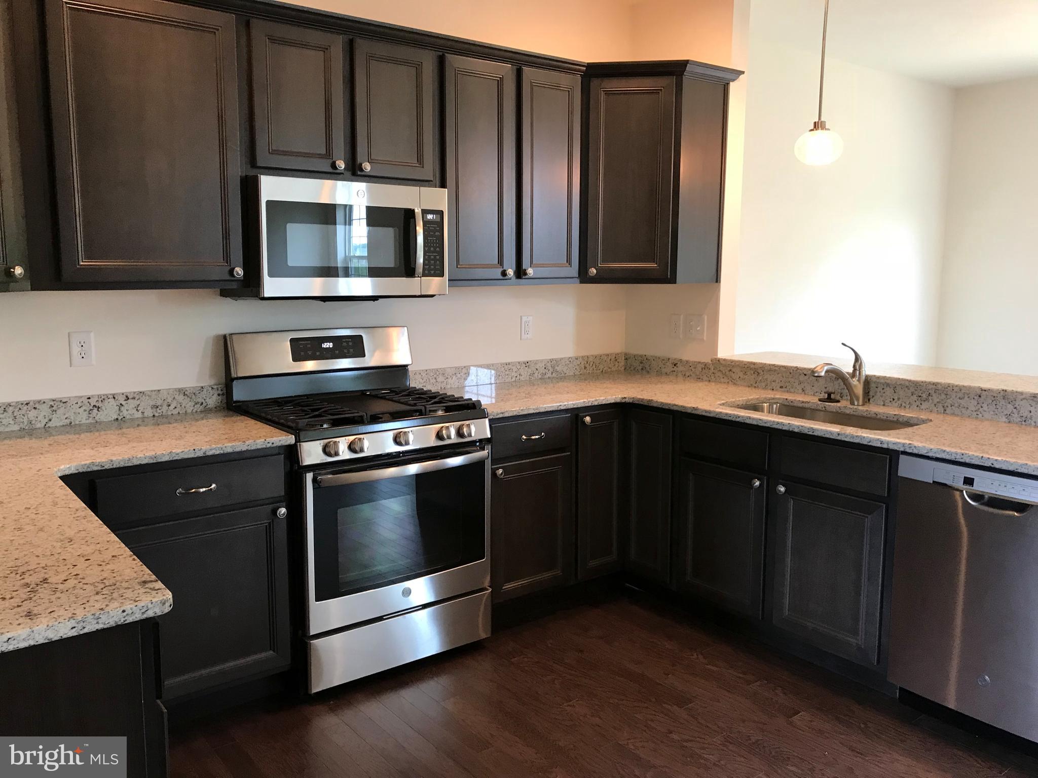 860 Ripple Drive, Unit 76 Hanover, PA 17331 - Photo 13 of 16 Kitchen- Granite, Stainless, gas stove, hardwoods