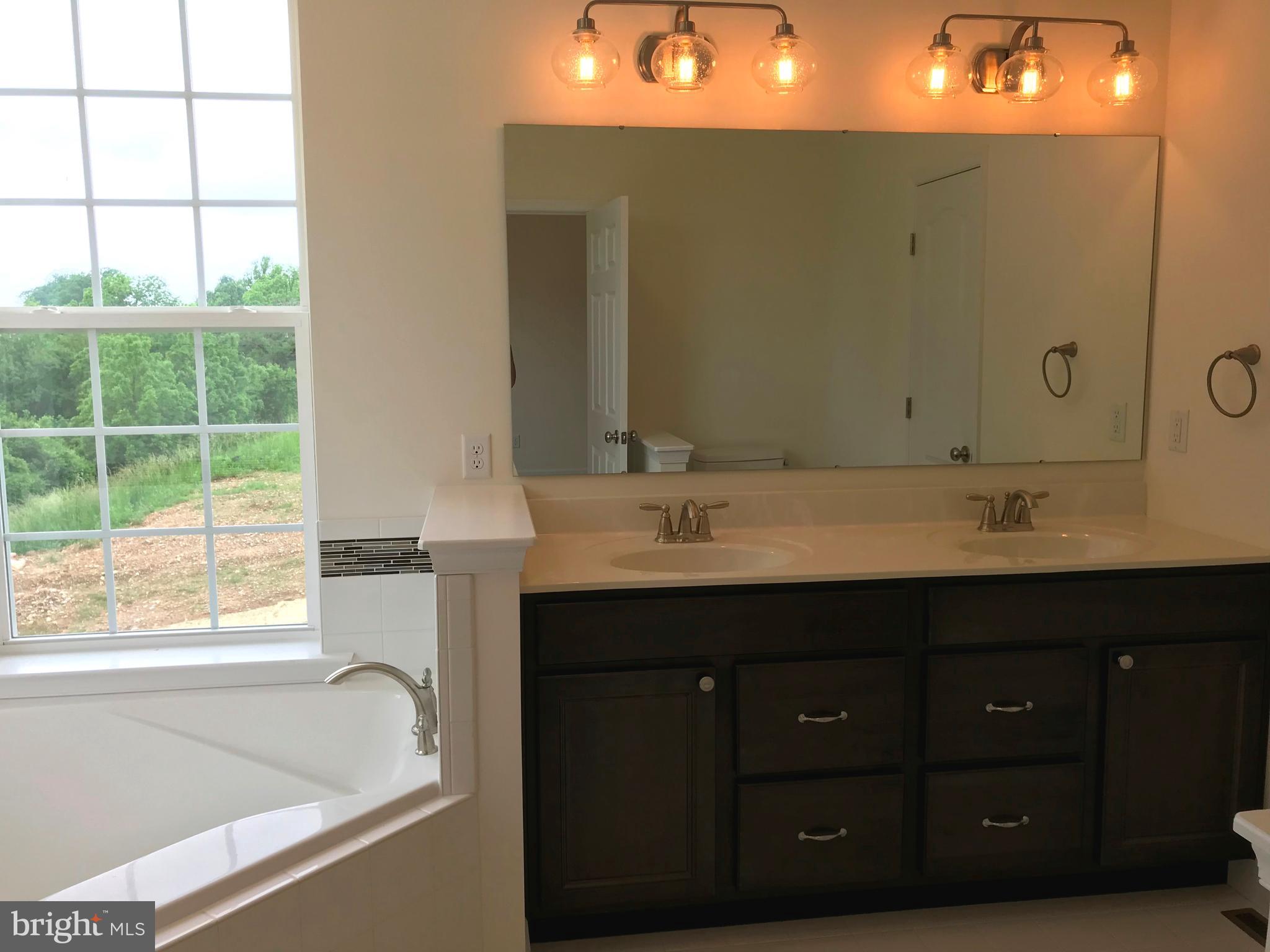 860 Ripple Drive, Unit 76 Hanover, PA 17331 - Photo 6 of 16 Master bath- tiled soaker tub, tall double vanity