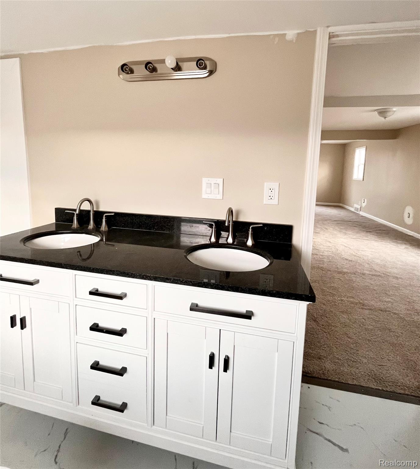 2410 Corunna Road Flint, MI 48503 - Photo 13 of 20 Bathroom featuring double vanity and light carpet