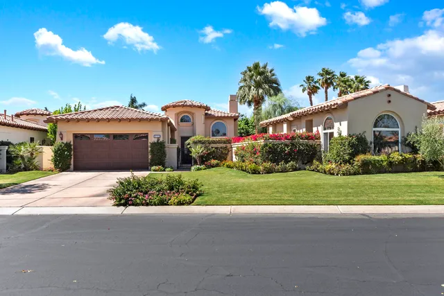 a view of a house with a yard and plants