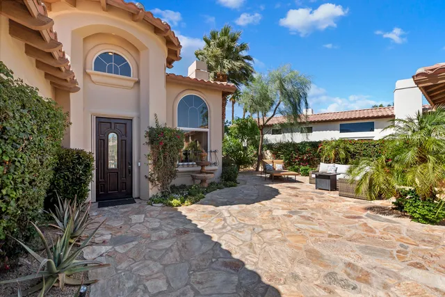 a backyard of a house with yard and outdoor seating