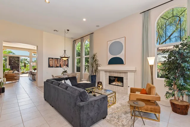 a living room with furniture fireplace and a window