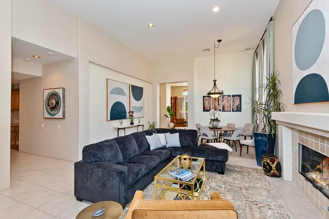 a living room with furniture a fireplace and a large window