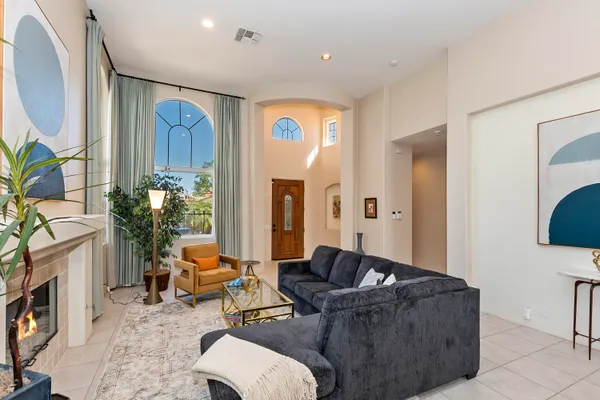 a dining room with furniture and a large window