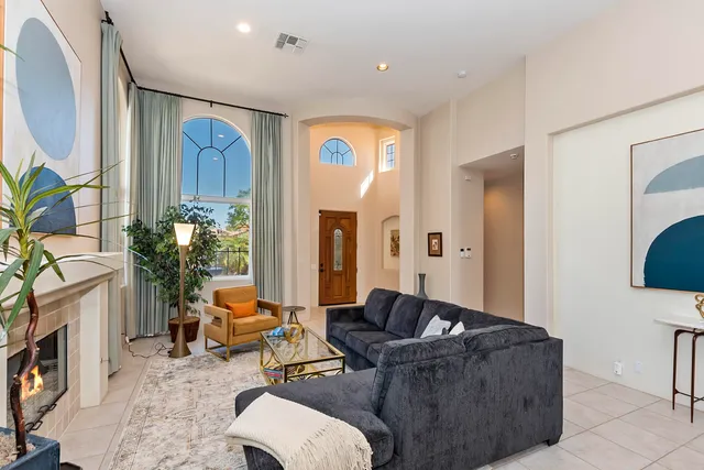 a dining room with furniture and a large window