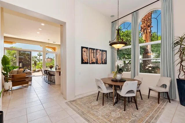 a reception area with glass top table and sofas