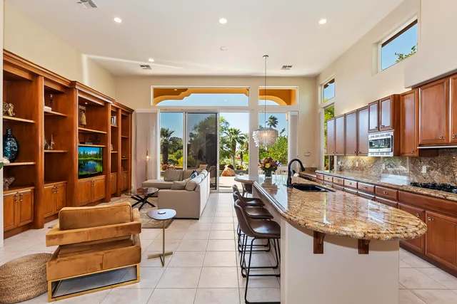 a kitchen with stainless steel appliances granite countertop sink and wooden floor