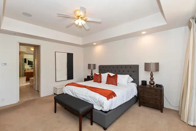a spacious bathroom with a granite countertop tub shower and mirror